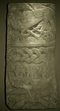 Carved stone showing Vikings and a ship