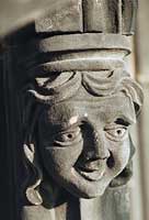 Carved, female grotesque character face 