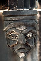 Carved, frowning grotesque character face 