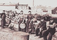 Joseph Johnston workers standing by barrels, c1900