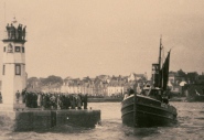 Fishing boat Violet leaving Anstruther for the Yarmouth herring fishery, around 1930 