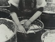 Woman packing herring into barrel with salt, c1910
