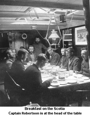 Photograph of breakfast on the Scotia. Captain Robertson is at the head of the table.